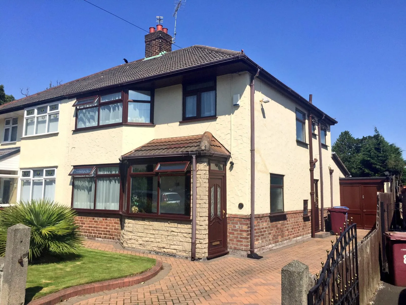 Side view of a cream-coated semi-detached house