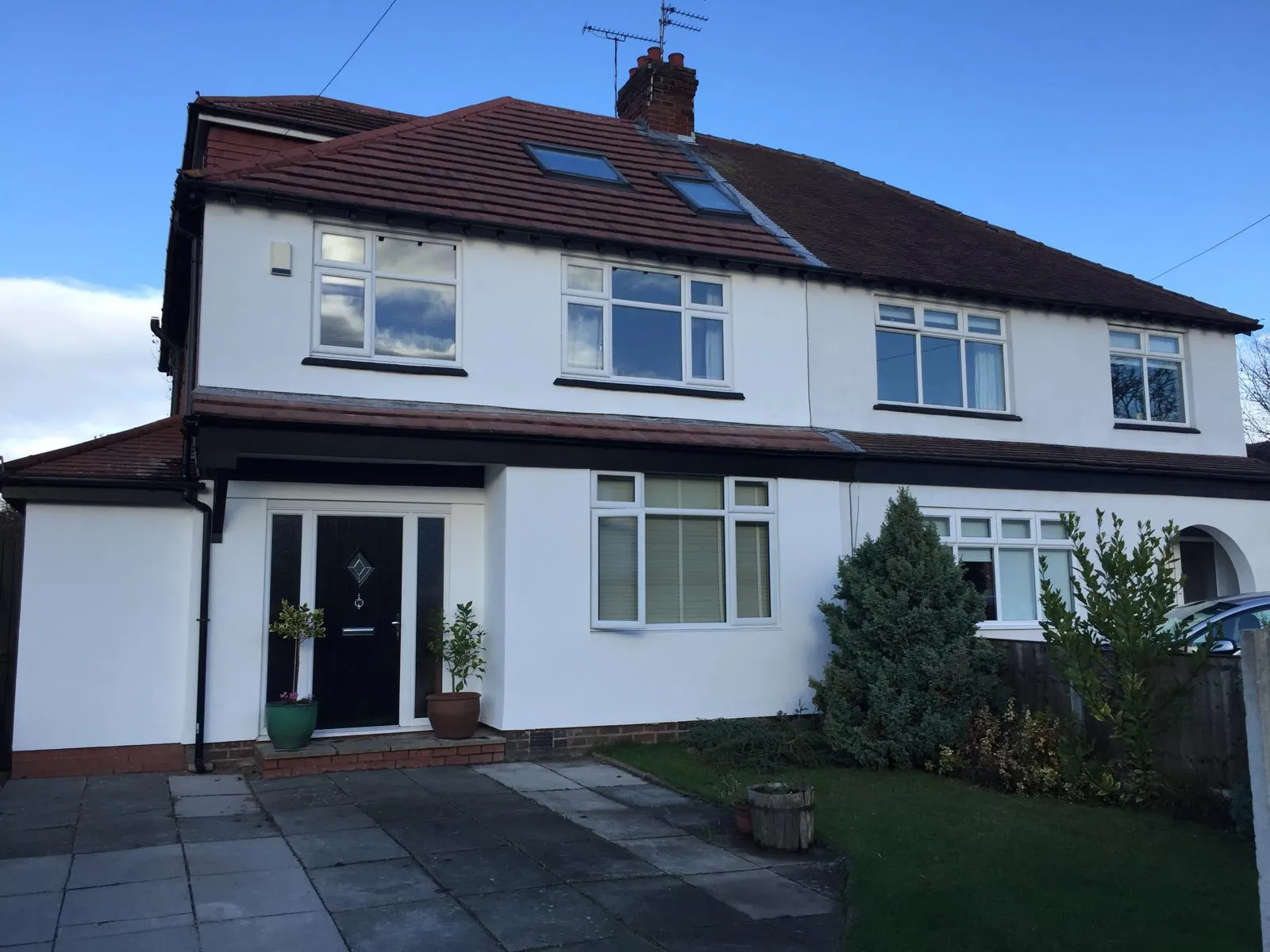 White semi-detached house with a completed façade coating