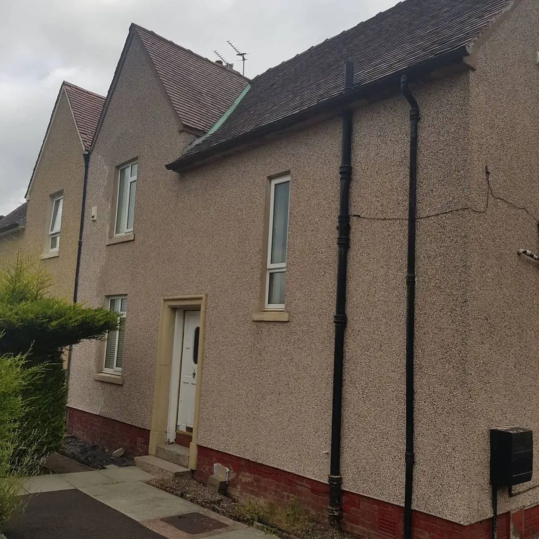 Rendered house before coating, dirty and weathered
