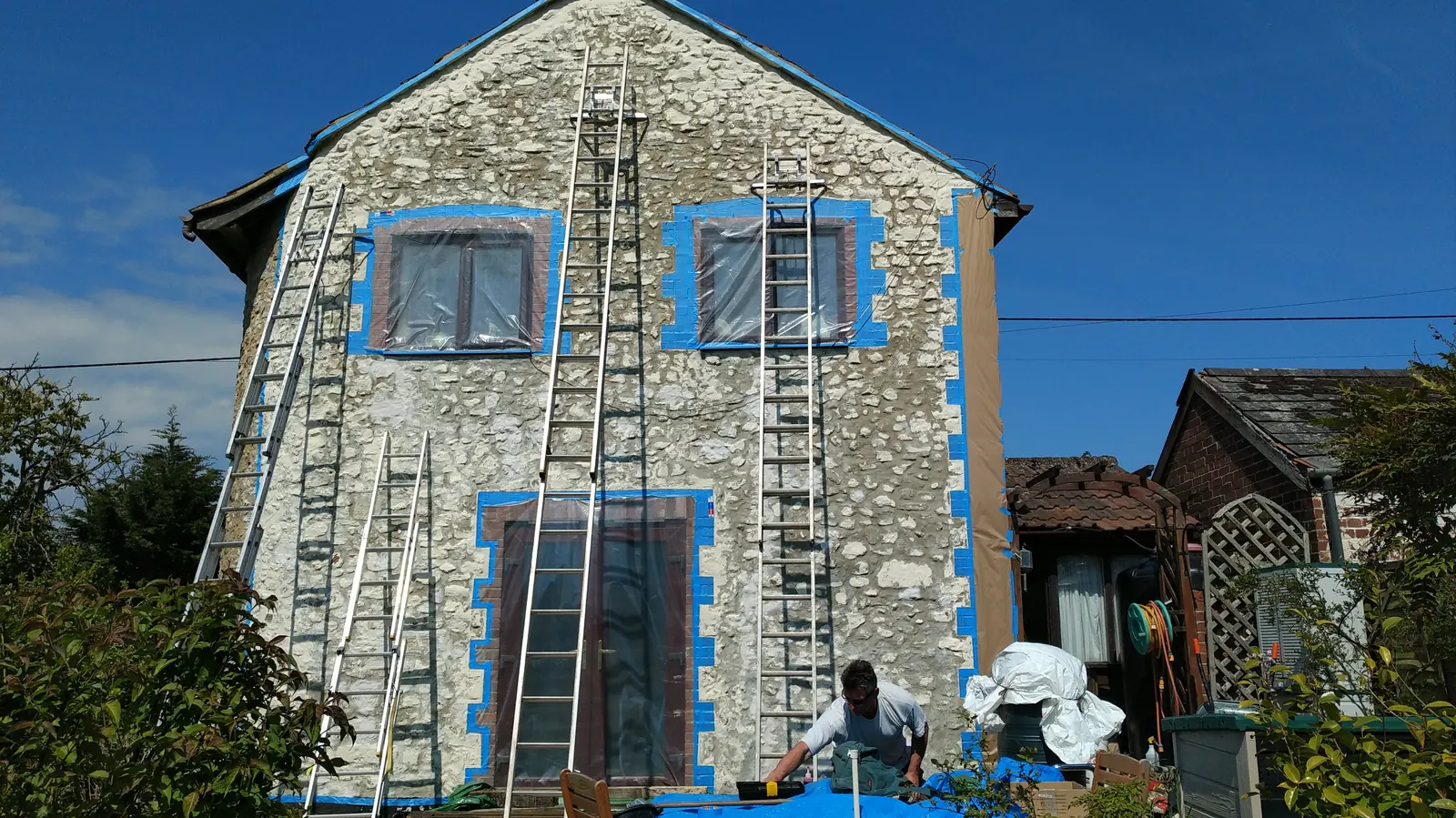 A rendered house masked up ready for façade coating